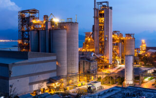 Close-up of a factory with lights on, displaying the industrial site and its facilities