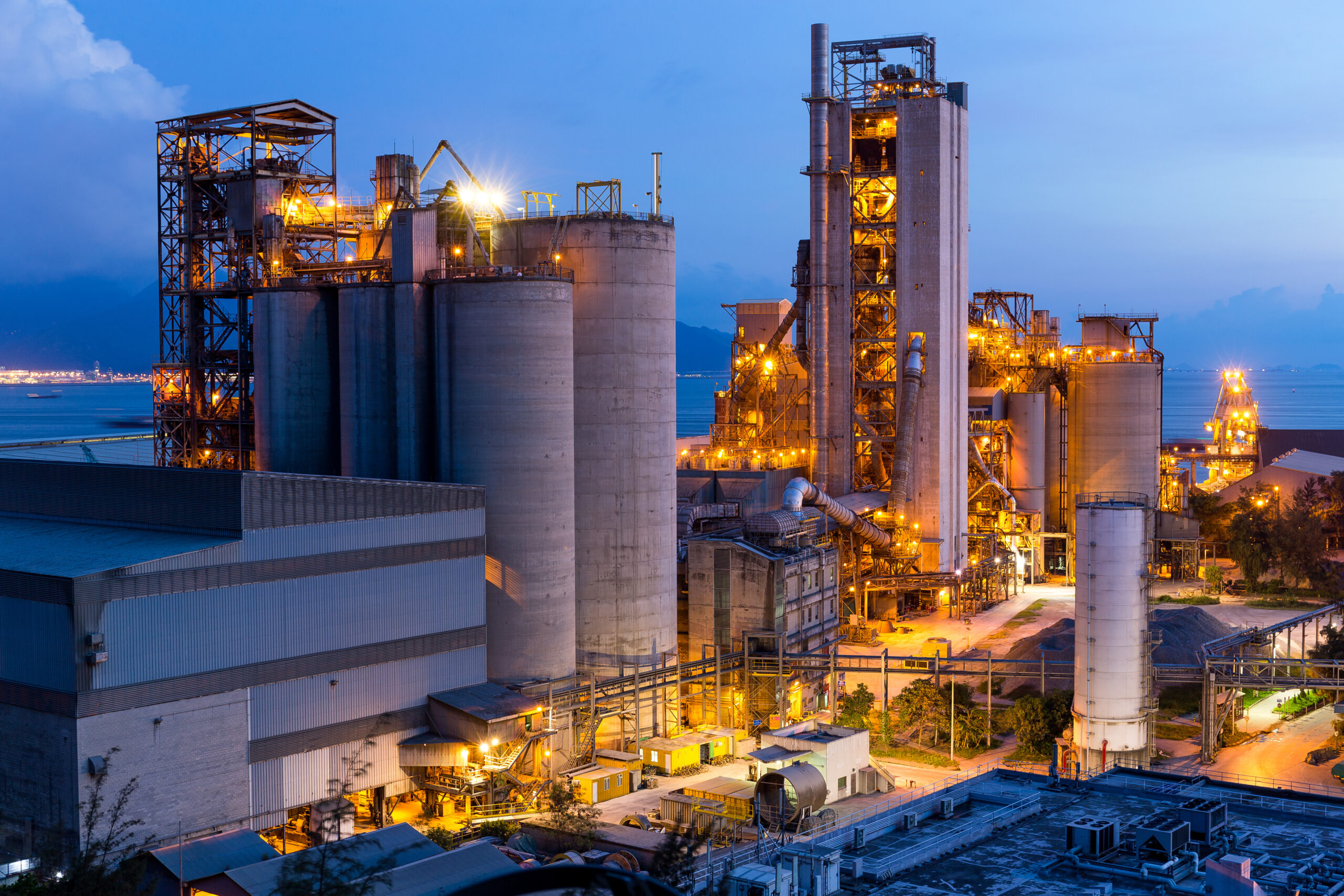 Close-up of a factory with lights on, displaying the industrial site and its facilities